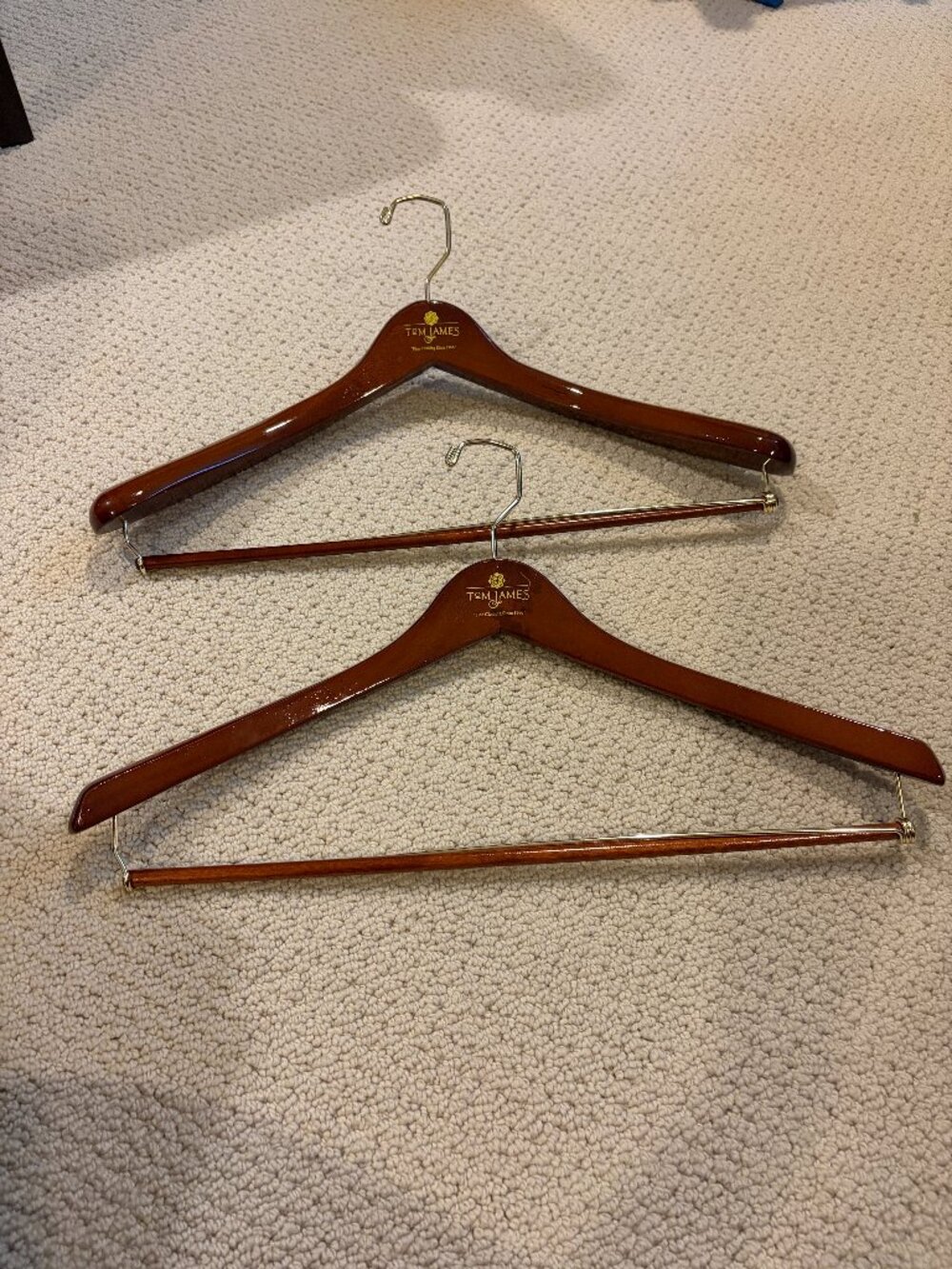 Tom James Wooden Suit Hangers with Bar set of 2, one is thicker than the other.